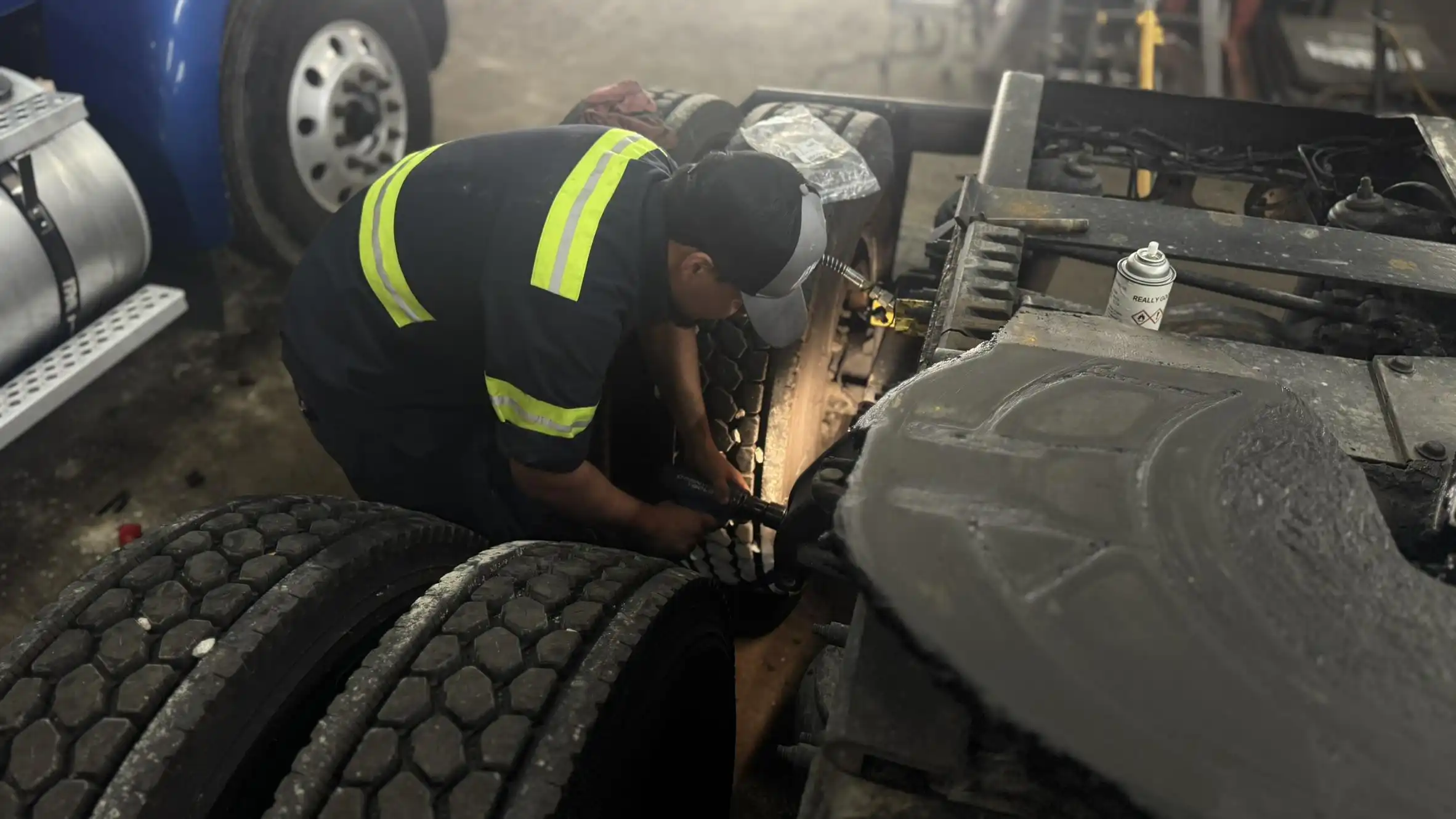 Technician repairing truck suspension