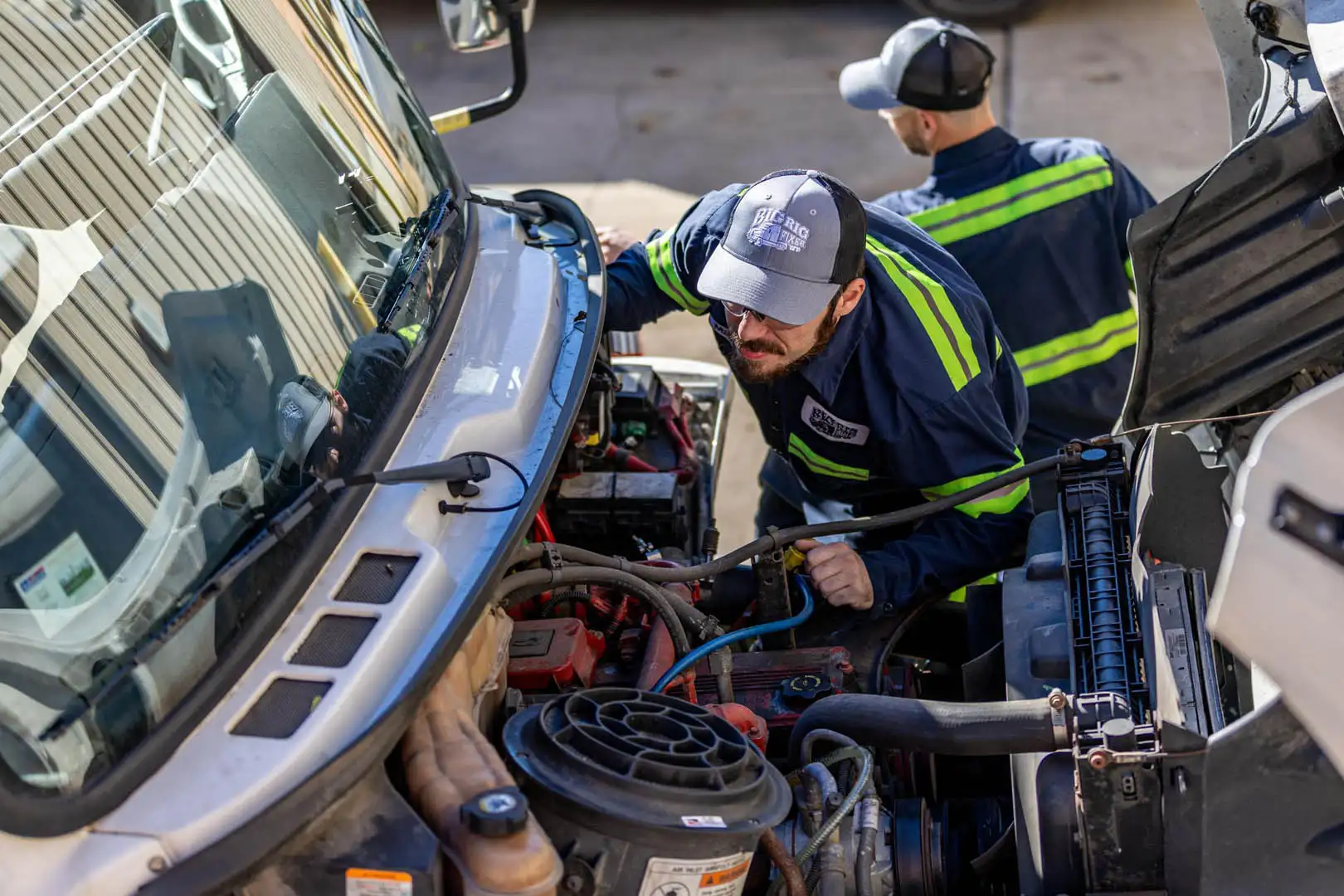 Technician looking at a diesel engine