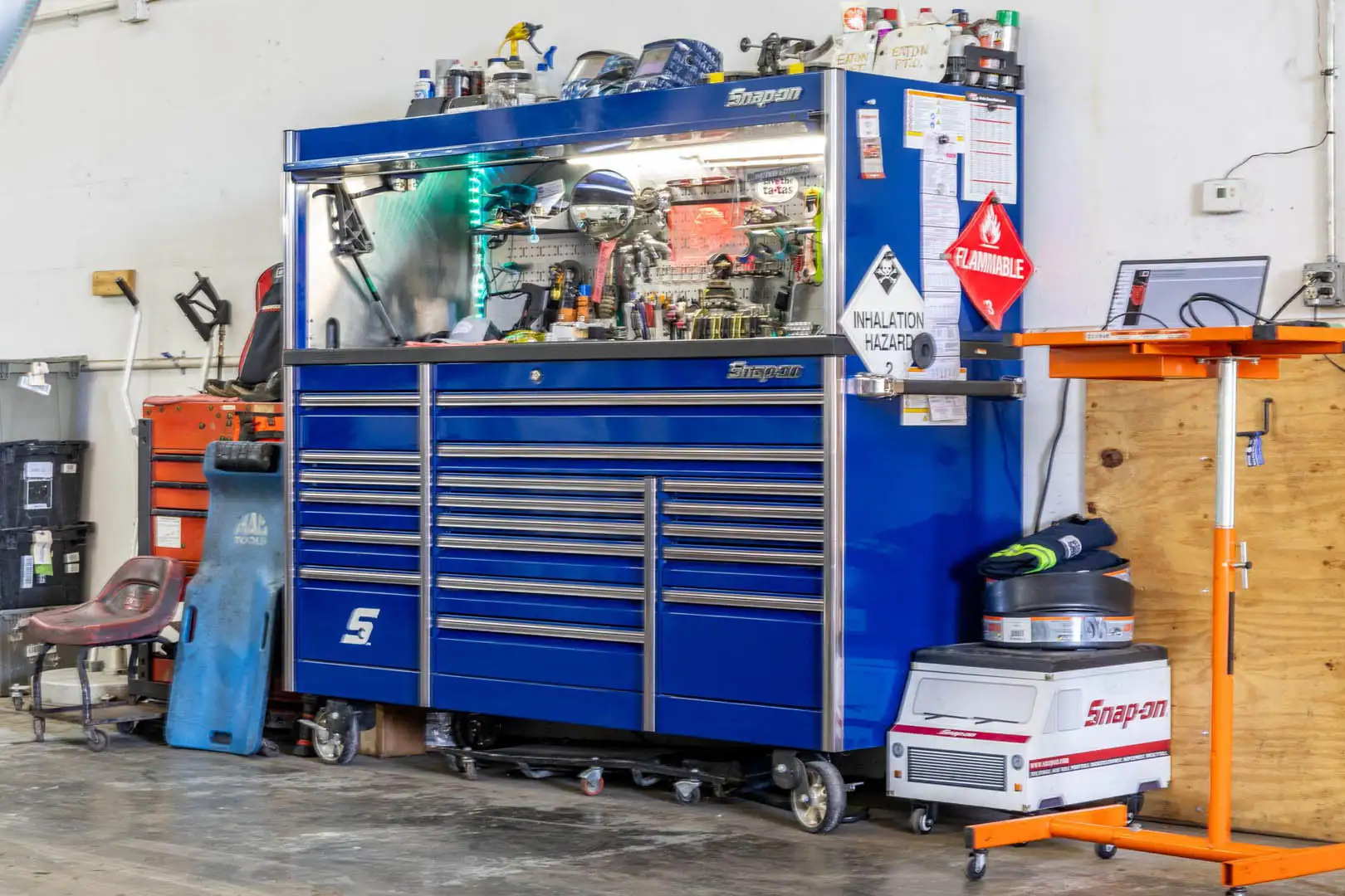 A technician's Snap-on tool cabinet and diagnostic laptop stand on the Big Rig Fixer shop floor
