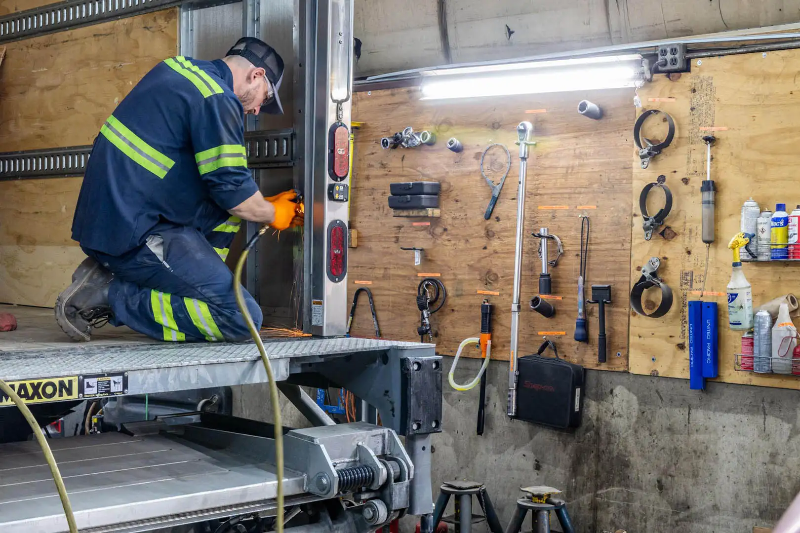 Technician repairing roll-up door hardware