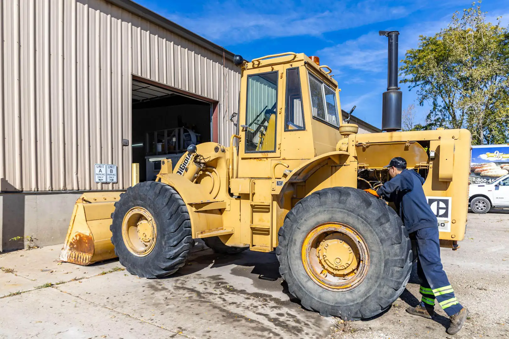Big Rig Fixer technician working on a yellow wheel loader