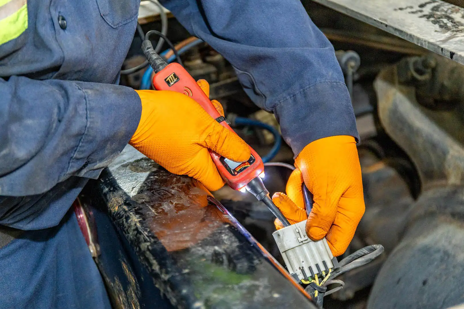 Technician repairing truck wiring harness