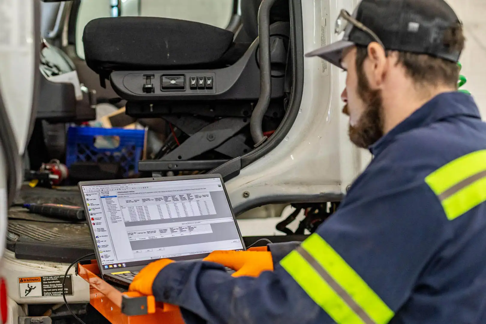 Technician performing OEM-level diagnostics on truck
