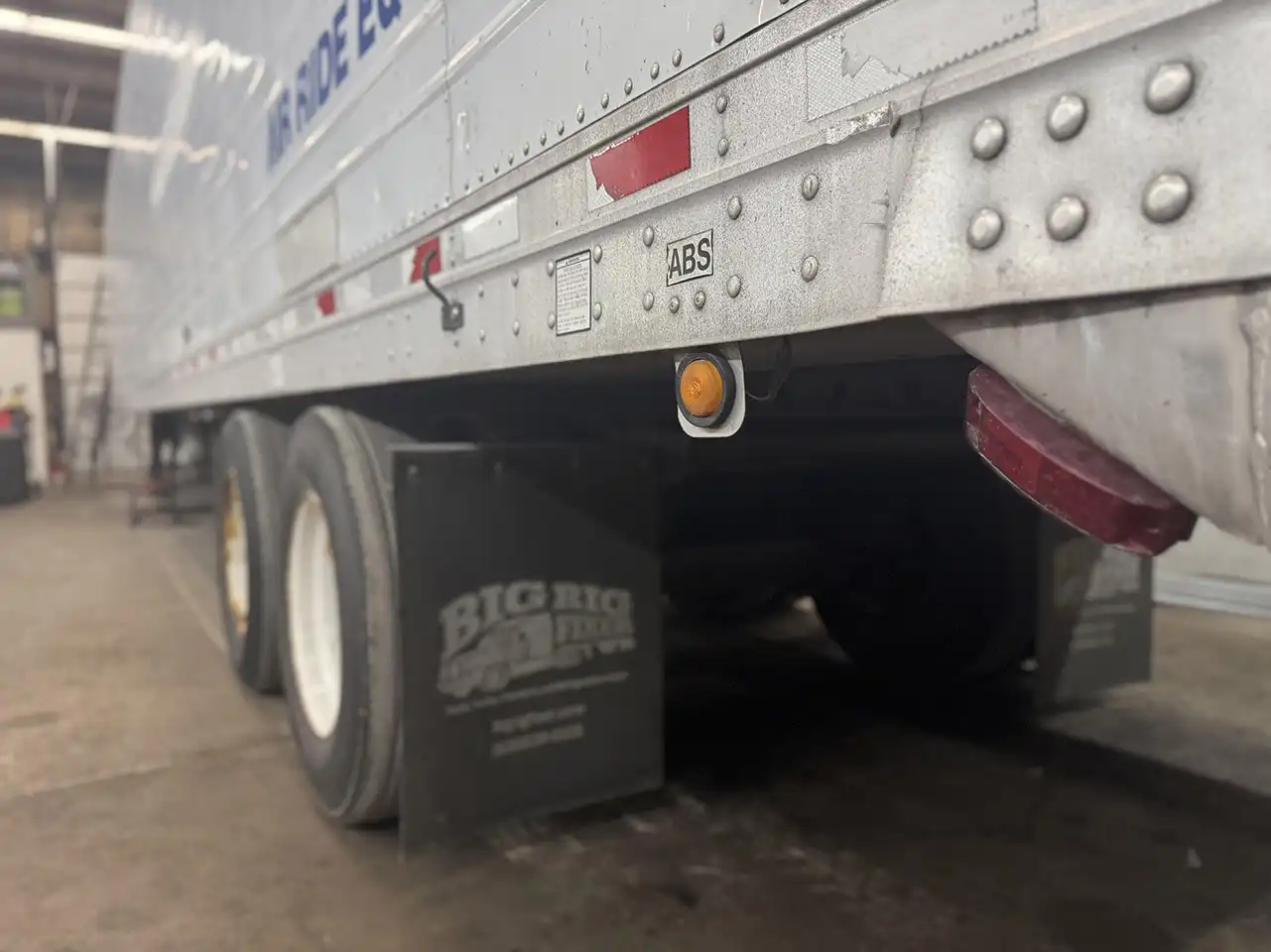 Technician using diagnostic tool on truck ABS system