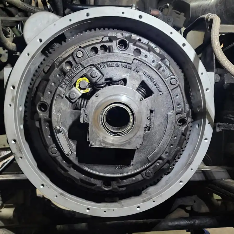 Technician removing transmission for clutch service