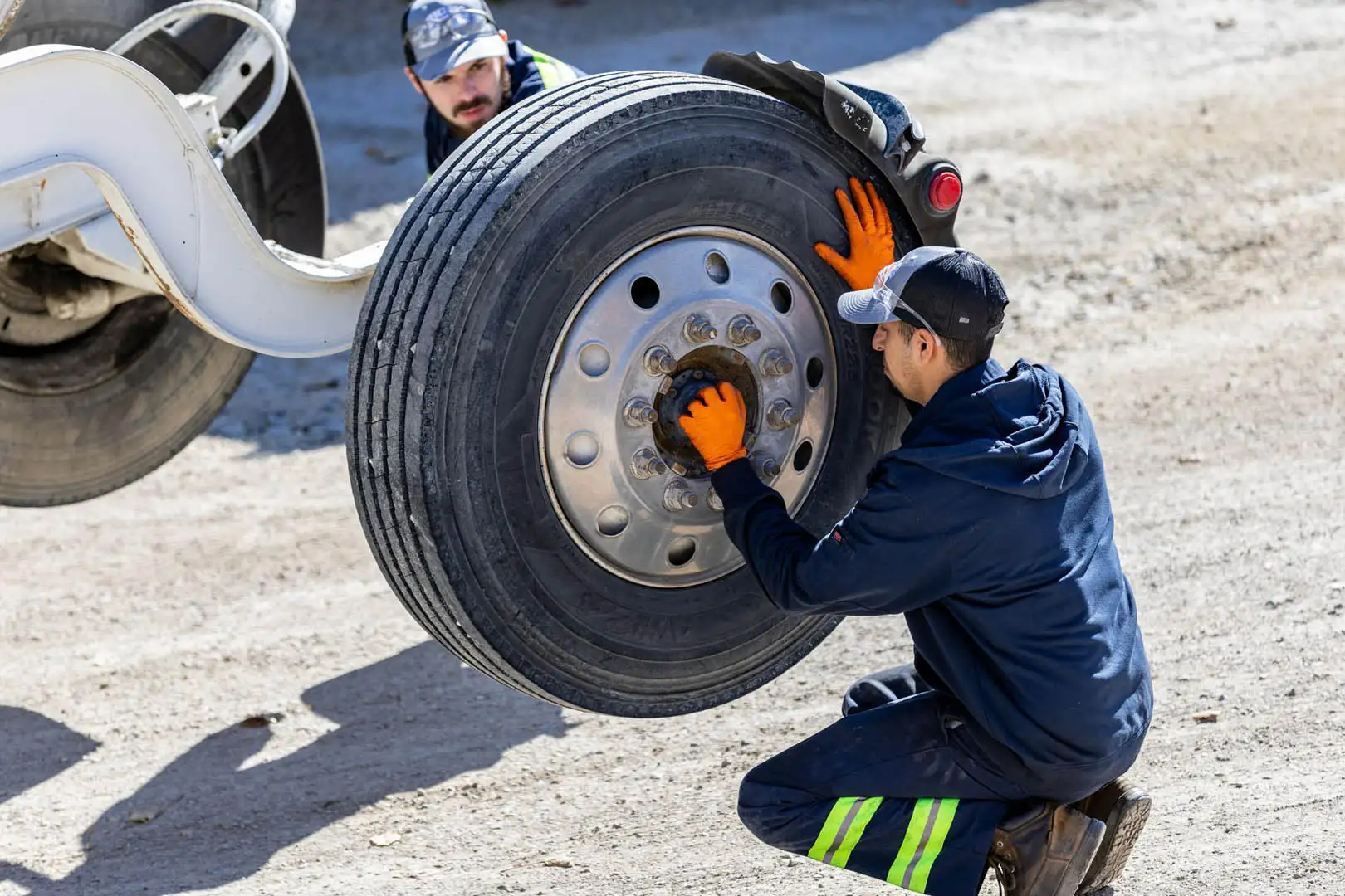 Technician mounting truck tire